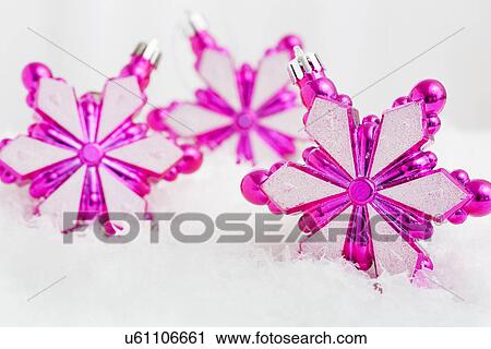 Christmas baubles in snow View Large Photo Image Stock Image - Christmas baubles in snow. Fotosearch