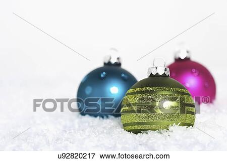 Christmas baubles on snow View Large Photo Image Stock Photo - Christmas baubles on snow. Fotosearch