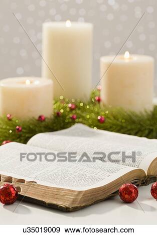 Stock Photo - Christmas candles and open bible. Fotosearch