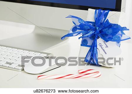 Stock Image - Christmas gift and computer. Fotosearch