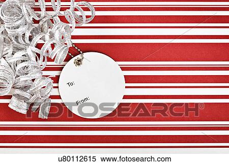 Christmas gift with ribbon and tag, studio shot View Large Photo Image Stock Photography - Christmas gift with ribbon and tag, studio shot. Fotosearch