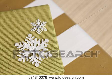 Christmas gifts with snowflake decoration, studio shot View Large Photo Image Stock Photograph - Christmas gifts with snowflake decoration, studio shot. Fotosearch