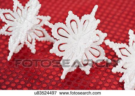 Christmas snowflake baubles on red View Large Photo Image Stock Photo - Christmas snowflake baubles on red. Fotosearch