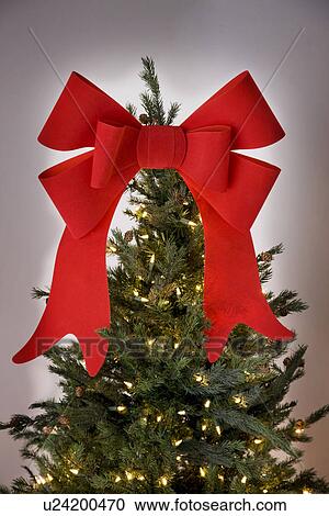 Christmas tree with red bow View Large Photo Image Stock Image - Christmas tree with red bow. Fotosearch