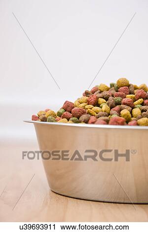 Close-up of bowl of dog food on wooden floor View Large Photo Image Stock Image - Close-up of bowl of dog food on wooden floor. Fotosearch