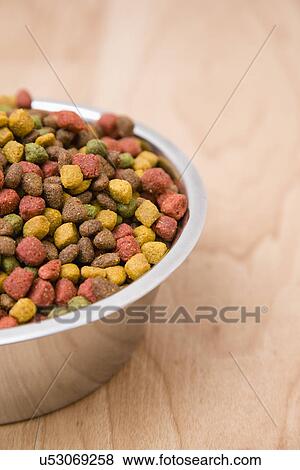 Close-up of bowl of dog food on wooden floor View Large Photo Image Stock Photo - Close-up of bowl of dog food on wooden floor. Fotosearch