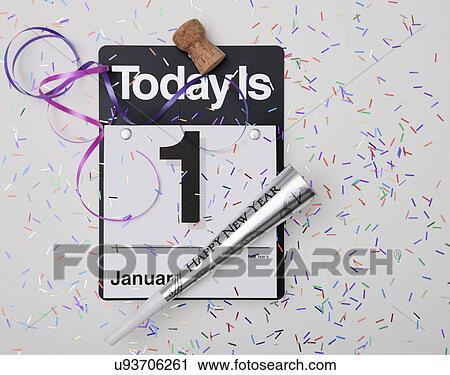 Stock Image - Close up of calendar with 1st January date and confetti. Fotosearch