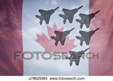 Picture - Close-up of Canadian flag with silhouettes of F-16 airplanes. Fotosearch