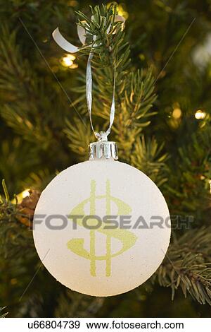 Stock Photo - Close up of Christmas ornament with dollar symbol. Fotosearch