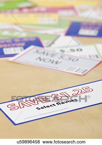 Close-up of coupons on table View Large Photo Image Stock Photo - Close-up of coupons on table. Fotosearch