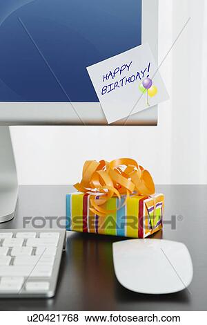 Close-up of desk in office with birthday gift View Large Photo Image Stock Photo - Close-up of desk in office with birthday gift. Fotosearch