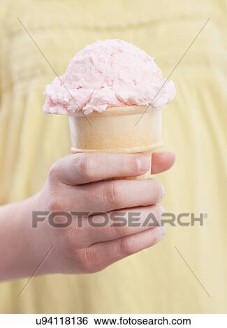 Close-up of girl's hand (10-11) holding ice cream View Large Photo Image Stock Photograph - Close-up of girl's hand (10-11) holding ice cream. Fotosearch