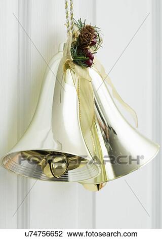Close up of golden bell hanging on door View Large Photo Image Stock Image - Close up of golden bell hanging on door. Fotosearch