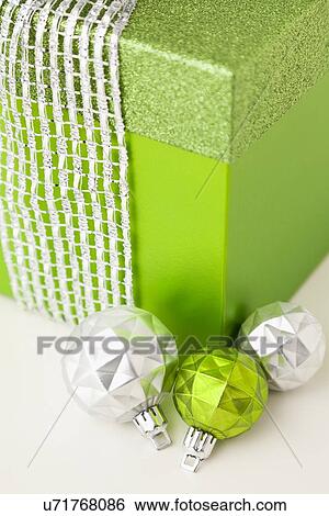 Close-up of green gift with christmas bulbs View Large Photo Image Stock Photograph - Close-up of green gift with christmas bulbs. Fotosearch