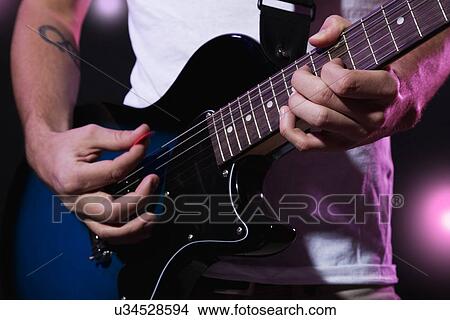 Close-up of guitar player View Large Photo Image Picture - Close-up of guitar player. Fotosearch