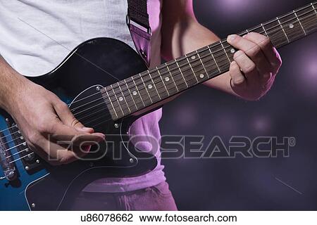 Close-up of guitar player View Large Photo Image Stock Image - Close-up of guitar player. Fotosearch