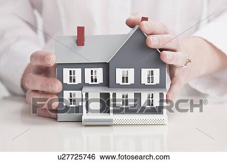 Close up of hands holding model house View Large Photo Image Stock Photograph - Close up of hands holding model house. Fotosearch