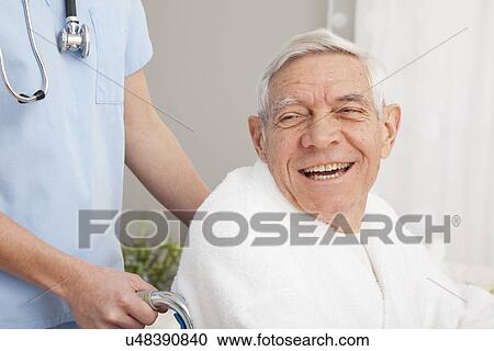 Close up of happy senior man assisted by nurse View Large Photo Image Stock Image - Close up of happy senior man assisted by nurse. Fotosearch