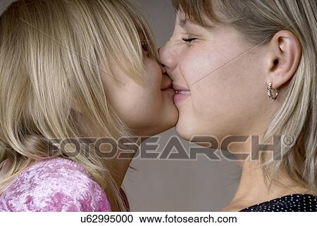 Stock Image - Close-up of mother and daughter (4-5) kissing. Fotosearch
