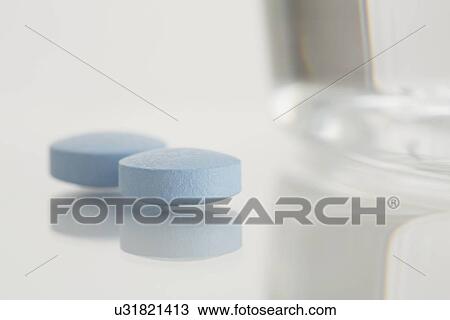 Close-up of painkiller and glass of water View Large Photo Image Stock Image - Close-up of painkiller and glass of water. Fotosearch