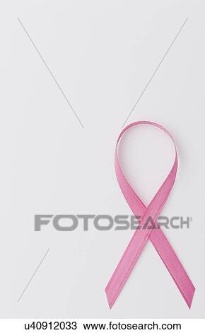 Stock Image - Close up of pink ribbon on white background. Fotosearch