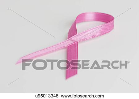 Stock Photograph - Close up of pink ribbon on white background. Fotosearch