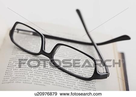 Close up of reading glasses on book, studio shot View Large Photo Image Stock Photo - Close up of reading glasses on book, studio shot. Fotosearch