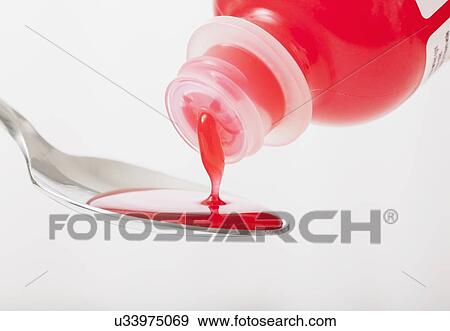 Close up of red cough medicine being poured on spoon, studio shot View Large Photo Image Stock Photo - Close up of red cough medicine being poured on spoon, studio shot. Fotosearch