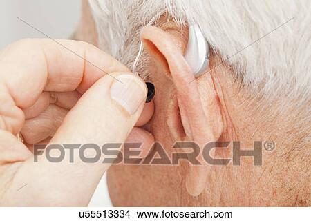 Close up of senior man's ear with hearing aid View Large Photo Image Picture - Close up of senior man's ear with hearing aid. Fotosearch