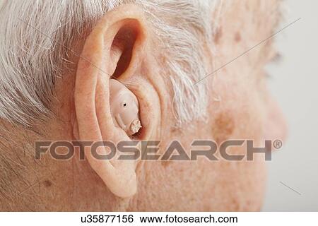 Close up of senior man's ear with hearing aid View Large Photo Image Stock Photograph - Close up of senior man's ear with hearing aid. Fotosearch