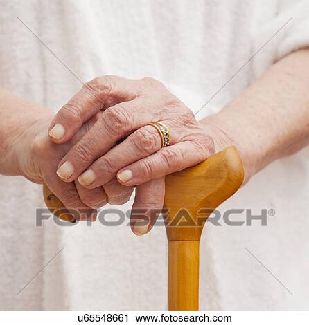 Close up of senior woman's hands on walking cane View Large Photo Image Stock Image - Close up of senior woman's hands on walking cane. Fotosearch