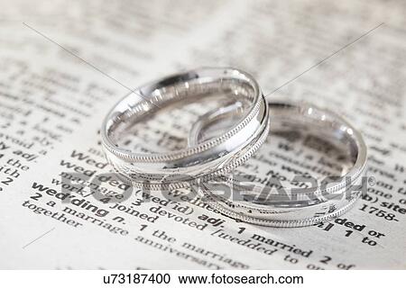 Close-up of silver wedding rings on dictionary page with "wedding" definition View Large Photo Image Stock Image - Close-up of silver wedding rings on dictionary page with "wedding" definition. Fotosearch