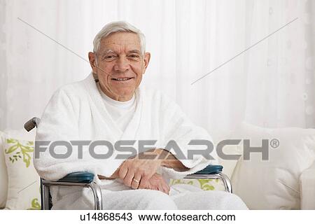 Stock Image - Close up of smiling senior man on wheelchair. Fotosearch