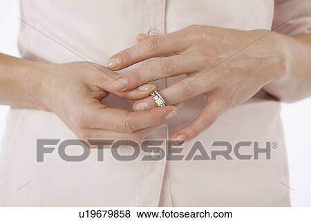 Close-up of woman removing wedding ring from finger View Large Photo Image Stock Photo - Close-up of woman removing wedding ring from finger. Fotosearch