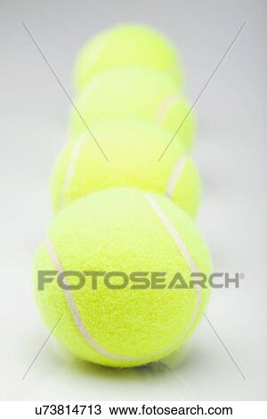 Close up of yellow tennis balls in row, studio shot View Large Photo Image Stock Image - Close up of yellow tennis balls in row, studio shot. Fotosearch