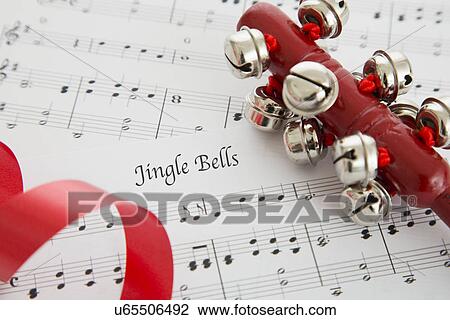 Stock Image - Close up view of music sheet and bells. Fotosearch