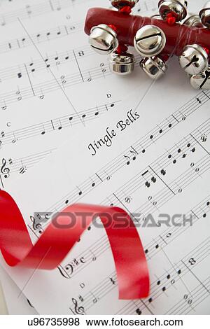 Stock Photo - Close up view of music sheet and bells. Fotosearch