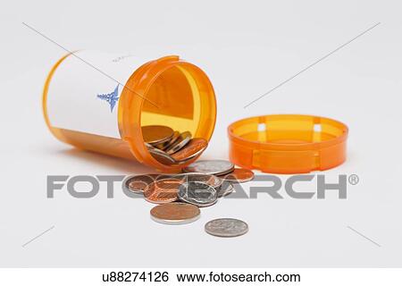 Stock Photograph - Coins inside pill container, studio shot. Fotosearch