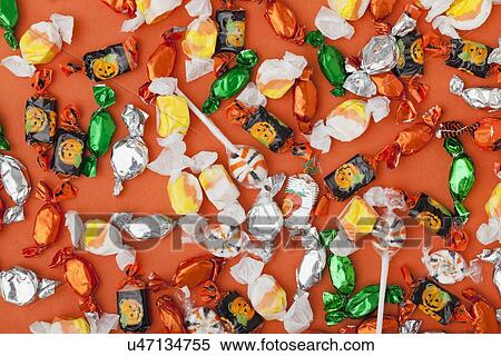 Stock Photography - Colorful candies on orange background. Fotosearch