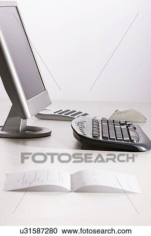 Stock Image - Computer and bill on office desk. Fotosearch