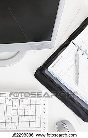 Computer and personal organizer on office desk, close-up View Large Photo Image Stock Photograph - Computer and personal organizer on office desk, close-up. Fotosearch