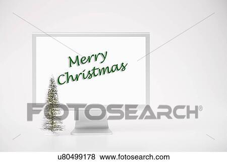 Computer monitor displaying merry Christmas phrase View Large Photo Image Stock Photo - Computer monitor displaying merry Christmas phrase. Fotosearch
