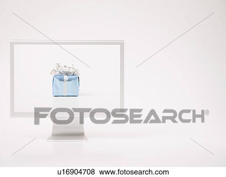 Stock Photo - Computer monitor with small gift. Fotosearch