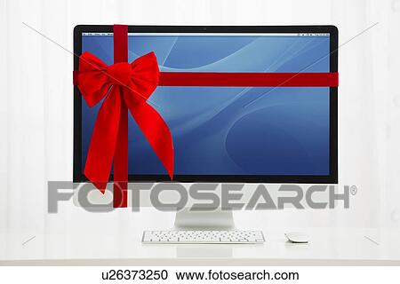 Stock Image - Computer with red bow . Fotosearch