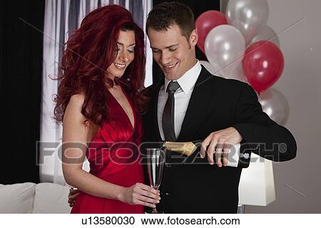 Stock Image - Couple celebrating with champagne. Fotosearch