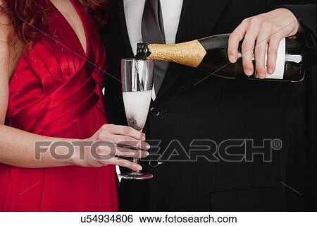 Stock Photograph - Couple celebrating with champagne. Fotosearch