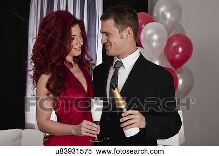 Stock Photography - Couple celebrating with champagne. Fotosearch