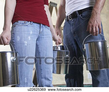 Couple holding paint cans, mid section View Large Photo Image Stock Photo - Couple holding paint cans, mid section. Fotosearch