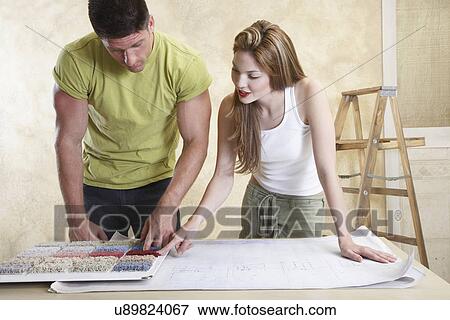 Couple looking at carpet samples and blueprint View Large Photo Image Stock Photo - Couple looking at carpet samples and blueprint. Fotosearch