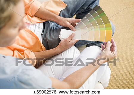 Couple looking at color samples, elevated view View Large Photo Image Stock Photograph - Couple looking at color samples, elevated view. Fotosearch